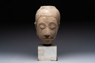 Three Southeast Asian bronze Buddhas and a stone head of Buddha, 18th C.
