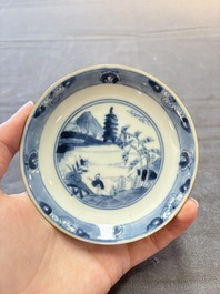 Four Chinese blue and white capucin-ground cups and saucers with landscape design, Yongzheng
