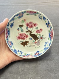 Three Chinese famille rose cups and saucers with a duck among flowering branches, Yongzheng/Qianlong