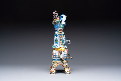A rare polychrome Dutch Delft figural wine cistern and cover, 18th C.