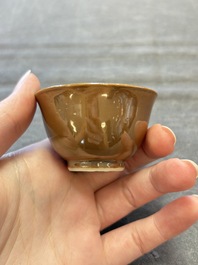 Four Chinese blue and white capucin-ground cups and saucers with landscape design, Yongzheng