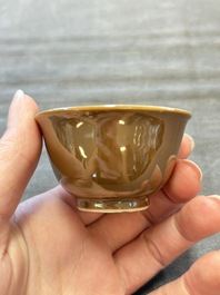 Four Chinese blue and white capucin-ground cups and saucers with landscape design, Yongzheng