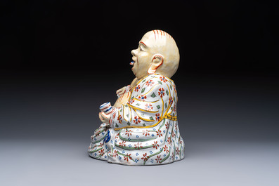 A polychrome Dutch Delft 'Budai' figure, 19th C.