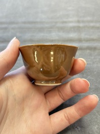Four Chinese blue and white capucin-ground cups and saucers with landscape design, Yongzheng