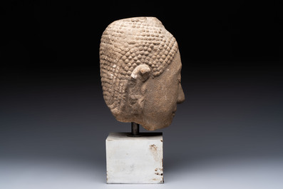 Three Southeast Asian bronze Buddhas and a stone head of Buddha, 18th C.