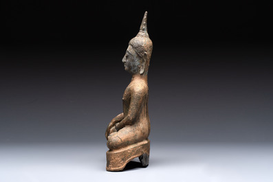 Three Southeast Asian bronze Buddhas and a stone head of Buddha, 18th C.
