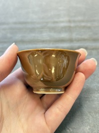 Four Chinese blue and white capucin-ground cups and saucers with landscape design, Yongzheng