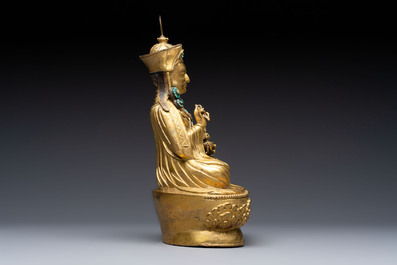 A Tibetan gilt-bronze figure of Padmasambhava holding a cup and a vajra, 17th C. or later