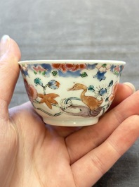 Three Chinese famille rose cups and saucers with a duck among flowering branches, Yongzheng/Qianlong