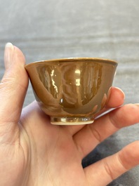 Four Chinese blue and white capucin-ground cups and saucers with landscape design, Yongzheng