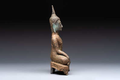Three Southeast Asian bronze Buddhas and a stone head of Buddha, 18th C.