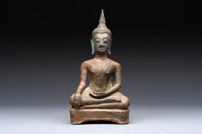 Three Southeast Asian bronze Buddhas and a stone head of Buddha, 18th C.
