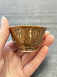 Four Chinese blue and white capucin-ground cups and saucers with landscape design, Yongzheng