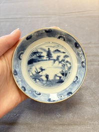 Four Chinese blue and white capucin-ground cups and saucers with landscape design, Yongzheng