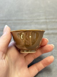 Four Chinese blue and white capucin-ground cups and saucers with landscape design, Yongzheng