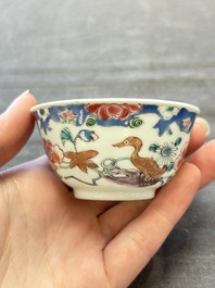 Three Chinese famille rose cups and saucers with a duck among flowering branches, Yongzheng/Qianlong