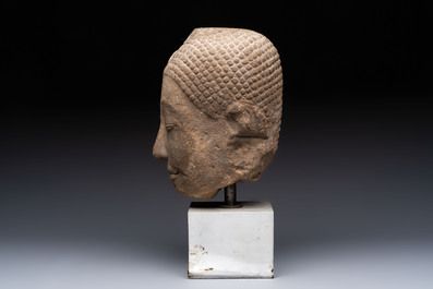 Three Southeast Asian bronze Buddhas and a stone head of Buddha, 18th C.