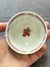 Three Chinese famille rose cups and saucers with a duck among flowering branches, Yongzheng/Qianlong