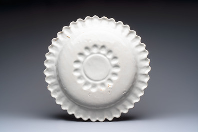 A large white-glazed Delftware 'sunburst' dish, France, 17th C.