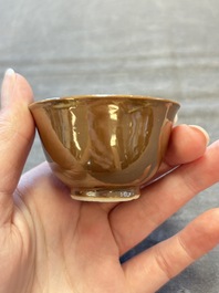 Four Chinese blue and white capucin-ground cups and saucers with landscape design, Yongzheng