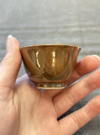 Four Chinese blue and white capucin-ground cups and saucers with landscape design, Yongzheng