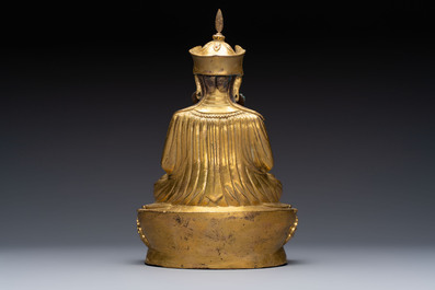 A Tibetan gilt-bronze figure of Padmasambhava holding a cup and a vajra, 17th C. or later
