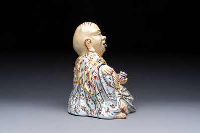 A polychrome Dutch Delft 'Budai' figure, 19th C.