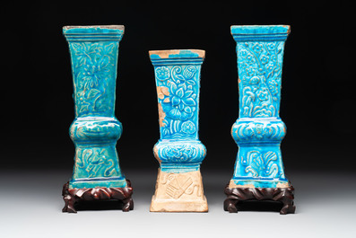 Three Chinese turquoise-glazed square 'gu' vases with floral design and two wooden stands, Ming