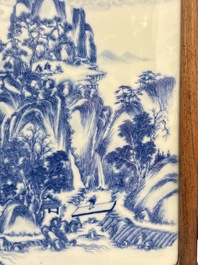 A Chinese blue and white 'mountainous landscape' plaque mounted in a wooden frame, 19/20th C.