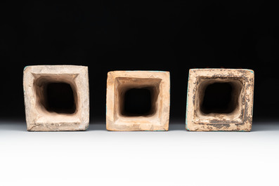 Three Chinese turquoise-glazed square 'gu' vases with floral design and two wooden stands, Ming