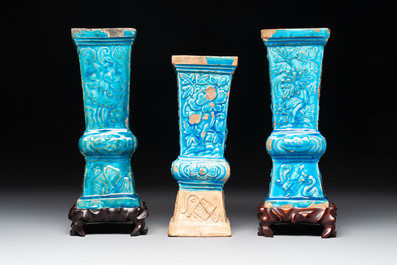 Three Chinese turquoise-glazed square 'gu' vases with floral design and two wooden stands, Ming