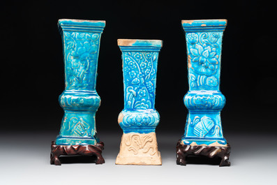 Three Chinese turquoise-glazed square 'gu' vases with floral design and two wooden stands, Ming