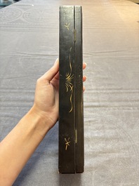 Two Chinese Canton gilt-lacquered and painted paper fans, one with its original box, 19th C.