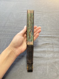 Two Chinese Canton gilt-lacquered and painted paper fans, one with its original box, 19th C.