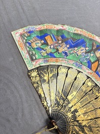 Two Chinese Canton gilt-lacquered and painted paper fans, one with its original box, 19th C.