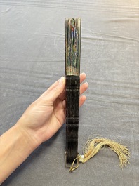Two Chinese Canton gilt-lacquered and painted paper fans, one with its original box, 19th C.