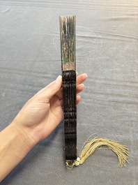 Two Chinese Canton gilt-lacquered and painted paper fans, one with its original box, 19th C.