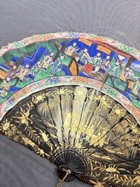 Two Chinese Canton gilt-lacquered and painted paper fans, one with its original box, 19th C.