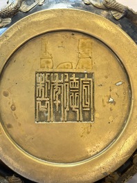 A Chinese bronze cylindrical censer with relief dragon design, Xuande mark, 18/19th C.