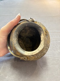 A rare Chinese parcel-gilt silver handled jar with floral scroll design, Tang