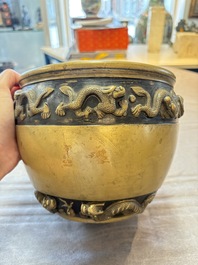 A Chinese bronze cylindrical censer with relief dragon design, Xuande mark, 18/19th C.