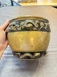 A Chinese bronze cylindrical censer with relief dragon design, Xuande mark, 18/19th C.