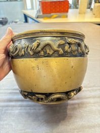 A Chinese bronze cylindrical censer with relief dragon design, Xuande mark, 18/19th C.
