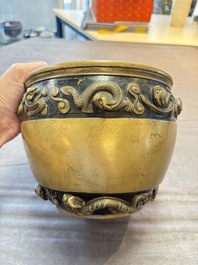 A Chinese bronze cylindrical censer with relief dragon design, Xuande mark, 18/19th C.
