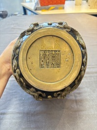 A Chinese bronze cylindrical censer with relief dragon design, Xuande mark, 18/19th C.