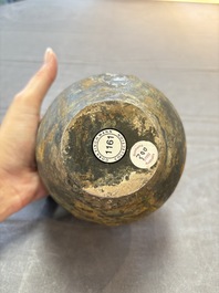 A rare Chinese parcel-gilt silver handled jar with floral scroll design, Tang
