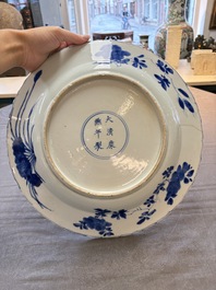 A Chinese blue and white dish with floral design, Kangxi mark and of the period