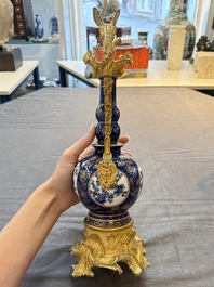 A pair of gilt-bronze-mounted Chinese famille verte powder-blue-ground double gourd vases, 19th C.