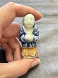 Nine Chinese blue, white, celadon-glazed and famille rose figures, 18/19th C.