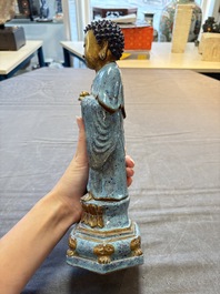 A Chinese robin's egg-glazed gilt-decorated standing Buddha, 18th C.